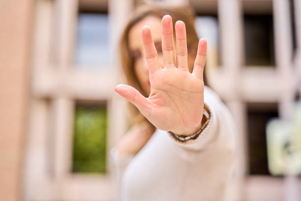 istock Woman making a stop hand gesture with focus on hand 2186204199