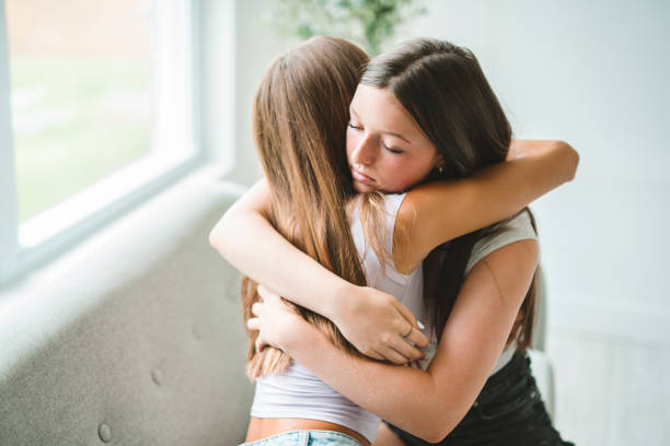 istock Two best girls consoling together sit on sofa 2186207666