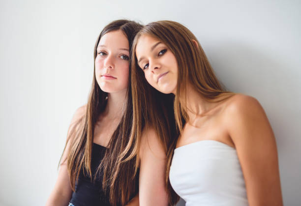 Subject: A group of young teen girls posing and having fun on white background.