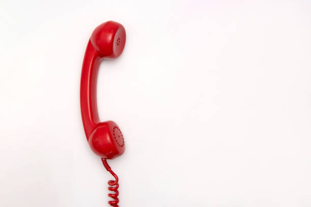 istock Vintage Red rotary telephone receiver with coiled cord on white background with copy space 2186214139