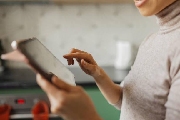 istock Focused Woman Engaged with Tablet in Cooking Space 2186218365