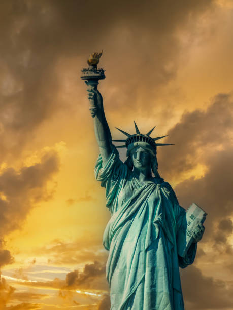 istock World famous Statue of Liberty under a dramatic sky at dusk 2186219510