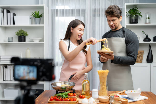 istock Chef influencers cooking special spaghetti with tongs to fried pan. Postulate. 2186220108