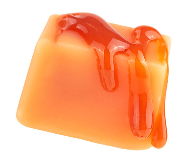istock Caramel candy and caramel sauce isolated on a white background. Levitating caramel candy. 2186223364