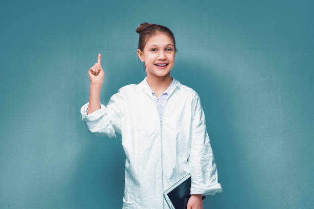 istock Young scientist girl having an idea and holding tablet computer 2186229580