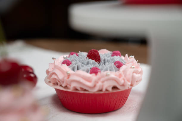 Presentation piece of cupcake on white standing cake with tea pot set in concept of pastel color's special cuisine. Content creative of social media with favorite sweets bakery dish. Tastemaker.