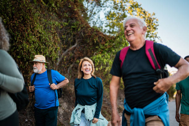 istock Senior friends walking and talking during hiking 2186232479