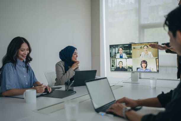 istock co-workers sitting in the meeting room and having a videoconference call with colleagues 2186233423