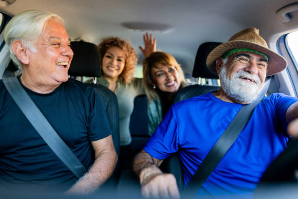 istock Senior friends talking inside car during road trip 2186233485