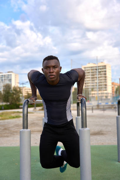 istock Young black man performing calisthenics in a city park 2186237092
