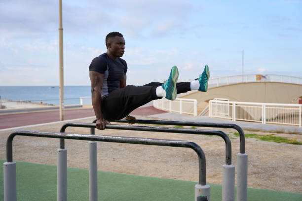 istock Young man performing calisthenics on parallel bars by the sea 2186237189