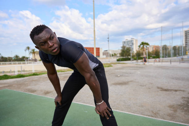 istock Young black athlete recovering after intense training session in urban park 2186237372