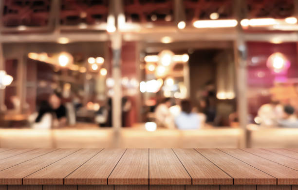 istock Empty wooden table top with lights bokeh on blur restaurant background. 2186240530