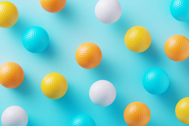 istock Colorful Golf Balls Scattered On Blue Background 2186244176