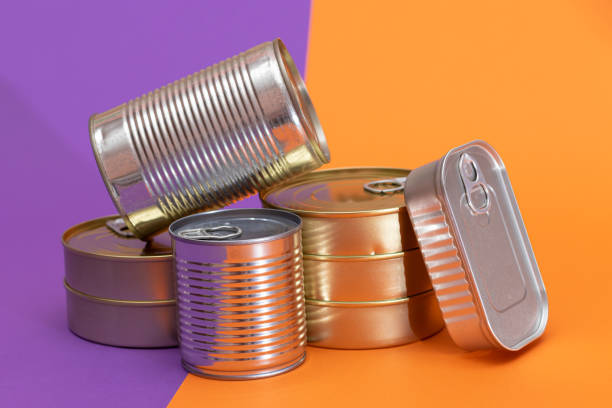 istock A Group of Stacked Tin Cans with Blank Edges on Split Orange and Violet Background 2186244217
