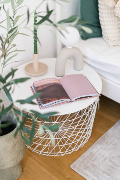 istock Cozy living room corner featuring decorative plant and open book on table 2186251853