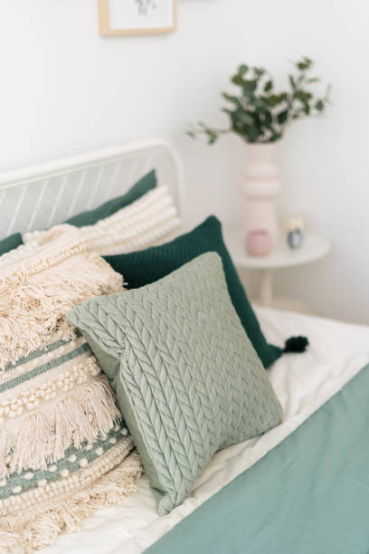 istock Cozy bedroom corner with decorative pillows and soft bedding accents 2186251870