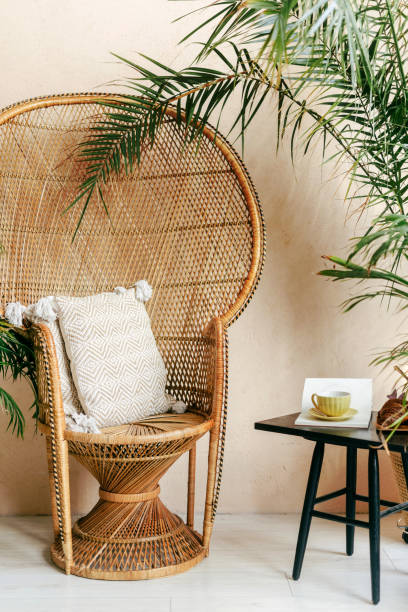 istock Cozy rattan chair surrounded by greenery in a sunny indoor space 2186251942