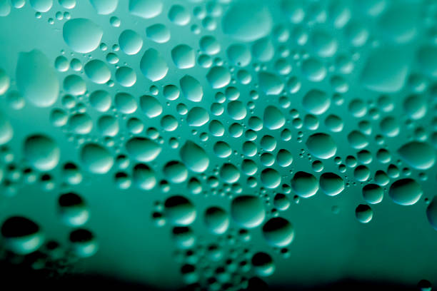 Water Condensation Small Bubbles Moisture on a Glass Green Window Close up