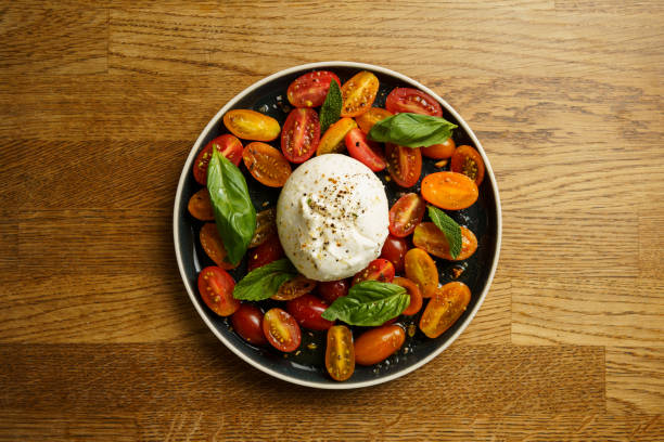 istock Burrata with cherry tomatoes and fresh basil 2186255606