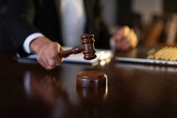 istock Judge holding a gavel in a courtroom making a decision 2186260630