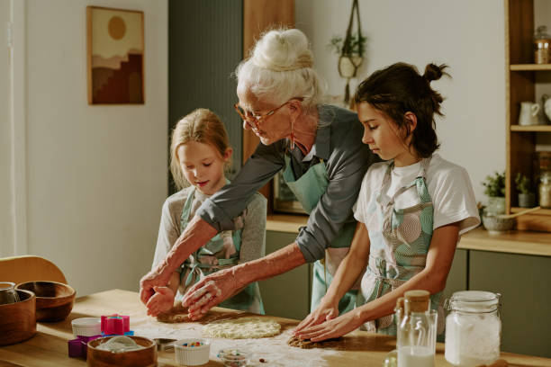 istock Senior Woman Guiding Kids in Kitchen Baking Activity 2186271981