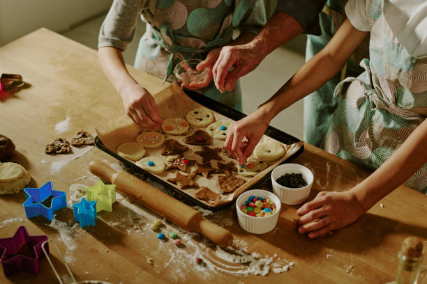 istock Children Decorating Holiday Cookies in Modern Kitchen 2186273126