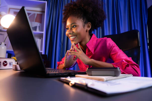 istock African blogger with happy face, looking on laptop with project. Tastemaker. 2186276247