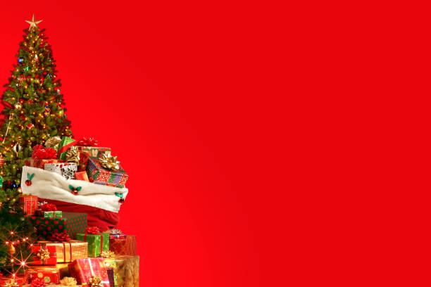 Close up or Santa Claus or Saint Nicholas wearing costume walking away after leaving presents and many gift boxes by Christmas tree. Merry Christmas and happy holidays concept