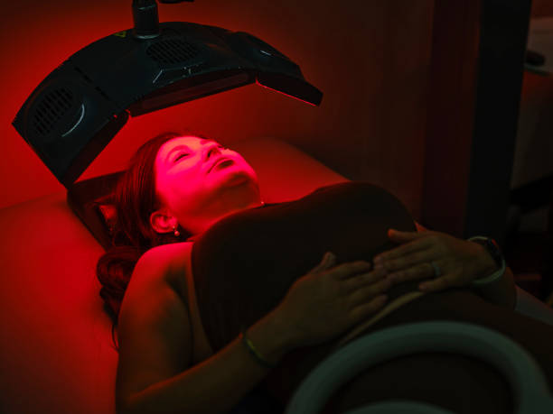 istock Woman On an LED Bed Receiving Red Light Therapy 2186283704