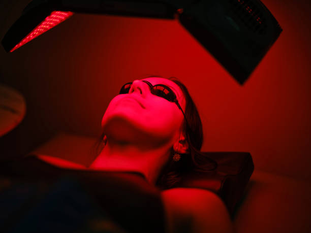 istock Woman On an LED Bed Receiving Red Light Therapy 2186284128