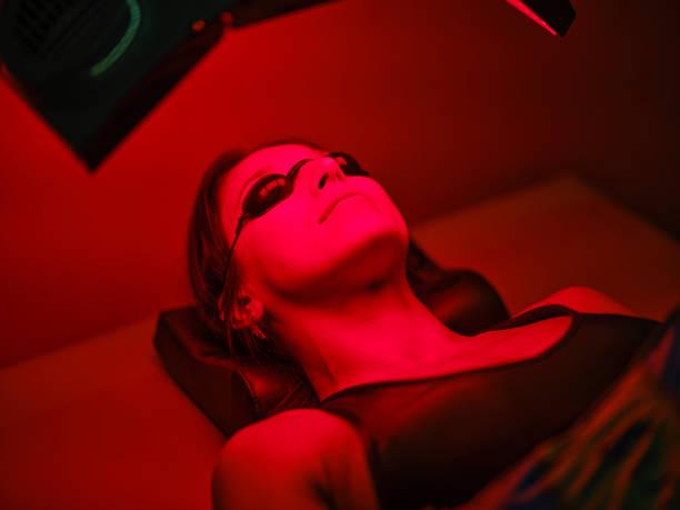 istock Woman On an LED Bed Receiving Red Light Therapy 2186284779