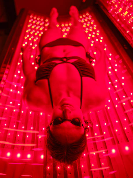 istock Woman On an LED Bed Receiving Red Light Therapy 2186285033