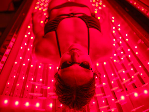 istock Woman On an LED Bed Receiving Red Light Therapy 2186285044