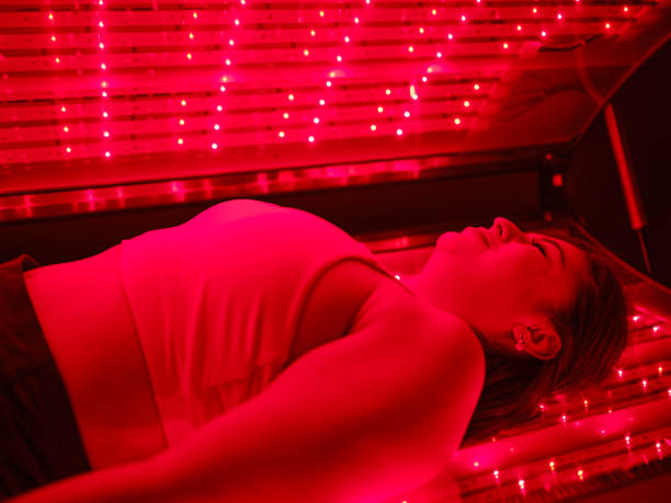 istock Woman On an LED Bed Receiving Red Light Therapy 2186285088