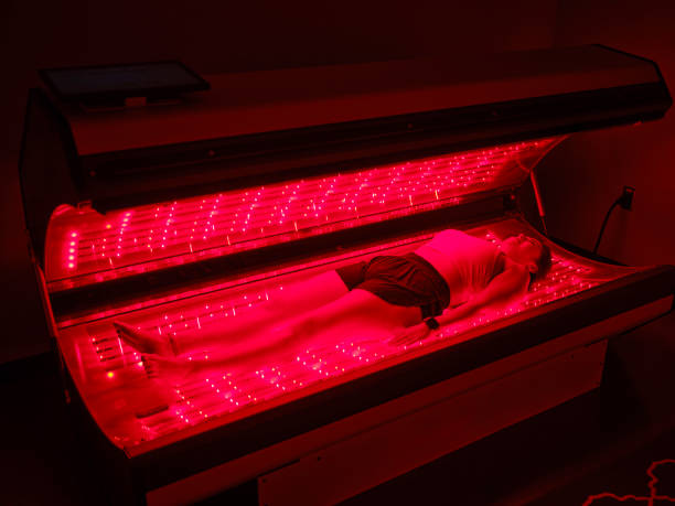 istock Woman On an LED Bed Receiving Red Light Therapy 2186285198