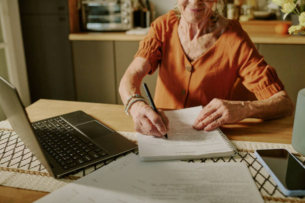 istock Elderly Woman Working on Documents in a Home Office 2186289072