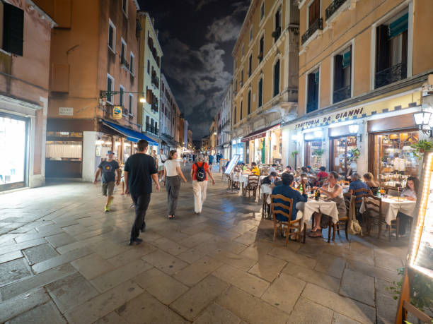 Venice, Italy - August 29 2024: Tourists on Strada Nova on the night time. Venice is a lagoon city and the capital of the Veneto region.