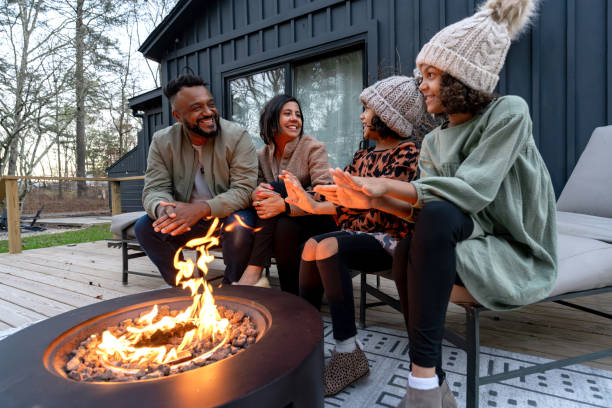 istock family in front of firepit relaxing in mountain house 2186306413