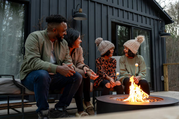 istock family in front of firepit relaxing in mountain house 2186306481