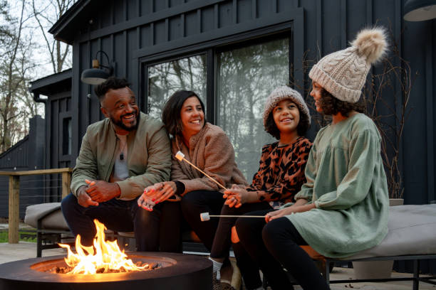 istock family in front of firepit relaxing in mountain house 2186306874