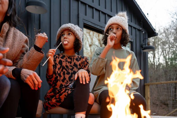 istock family in front of firepit relaxing in mountain house 2186306966
