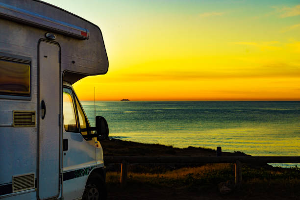 istock Camper vehicle on beach at sunrise 2186312648