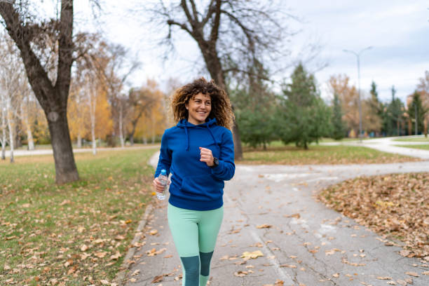 istock Young female athlete jogging outdoors 2186315471