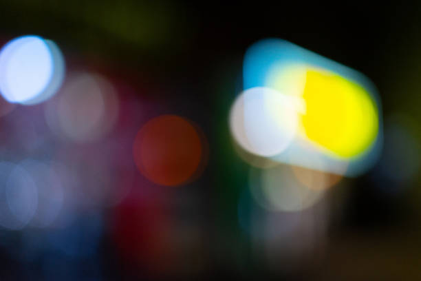 A mix of blue, green, and yellow tones in a soft focus highlights a serene nighttime city ambiance.