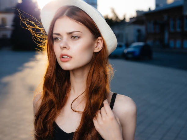 pretty woman in a hat outdoors summer posing. High quality photo