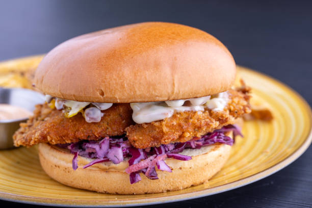 istock fresh fried chicken burger close up with fries on plate 2186330722