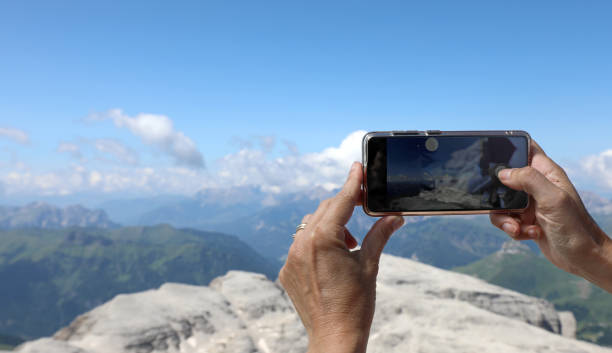 istock hand photographing breathtaking mountain view with modern smartphone 2186332089