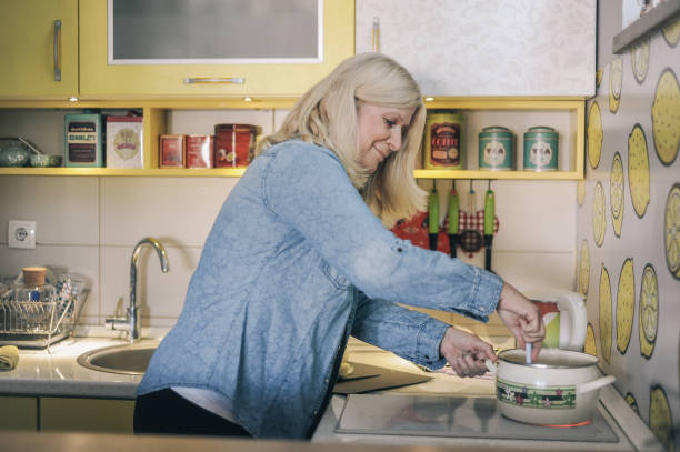 Senior Woman Cooking in Retro Kitchen