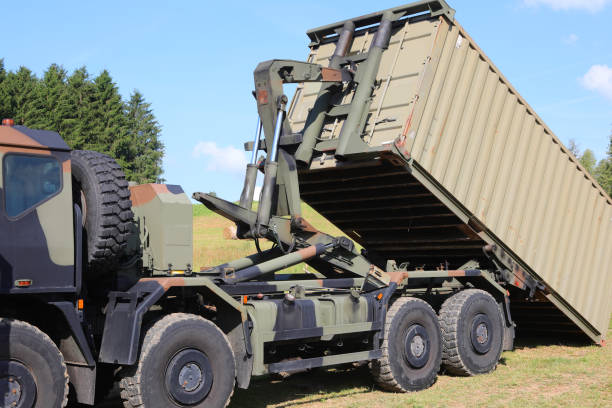 istock Military truck transporting war supplies while unloading container at the battlefield 2186332222